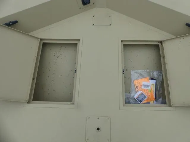 Slide: The Image of 2025 Lowe rx20CC boat interior with camouflage seating, steering console, and spacious layout. - 7