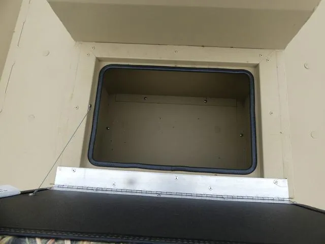 Slide: The Image of Open storage compartment in a 2025 Lowe rx20CC boat. - 9