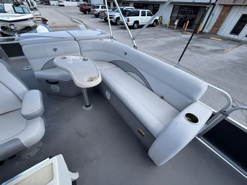 Slide: The Image of 2013 Tahoe Pontoon AF 2280 FF with spacious seating and table on deck. - 14