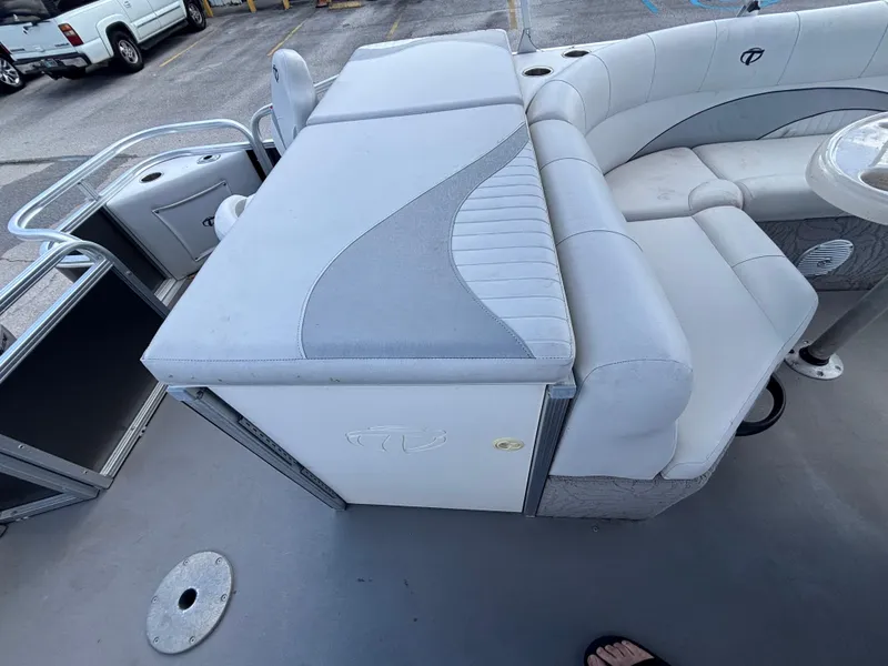 Slide: The Image of 2013 Tahoe Pontoon AF 2280 FF interior with gray seating and storage compartments. - 16