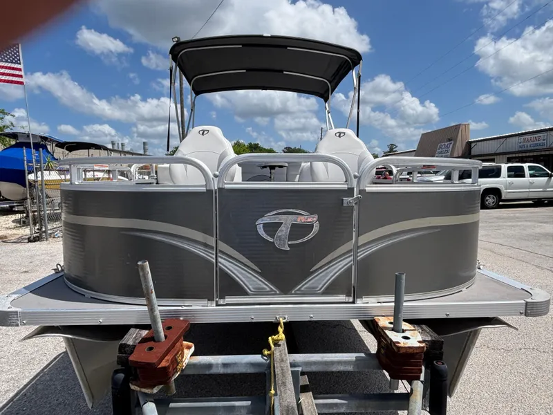 Slide: The Image of 2013 Tahoe Pontoon AF 2280 FF boat on trailer, under a sunny sky. - 2