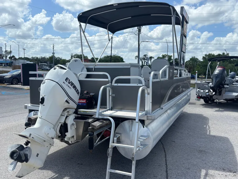 Slide: The Image of 2013 Tahoe Pontoon AF 2280 FF with Evinrude outboard motor, parked on pavement. - 3