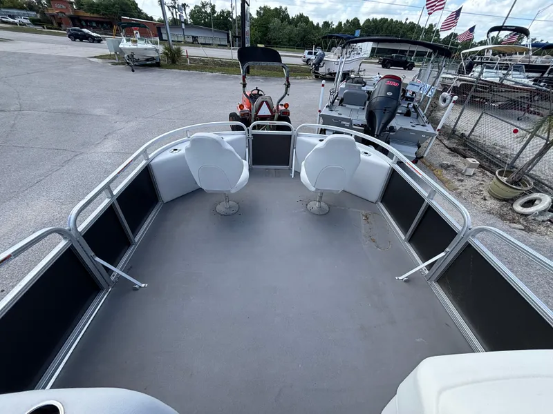 Slide: The Image of 2013 Tahoe Pontoon AF 2280 FF boat interior with seating, parked in a lot. - 8
