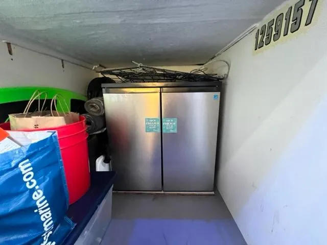 Slide: The Image of Storage area on a 2014 Jeanneau NC14 boat with a stainless steel fridge. - 12