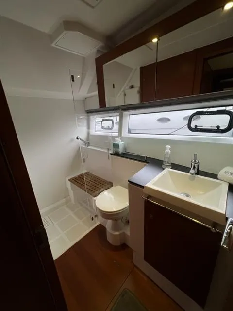 Slide: The Image of Bathroom interior of 2014 Jeanneau NC14 yacht with modern fixtures and wooden accents. - 15