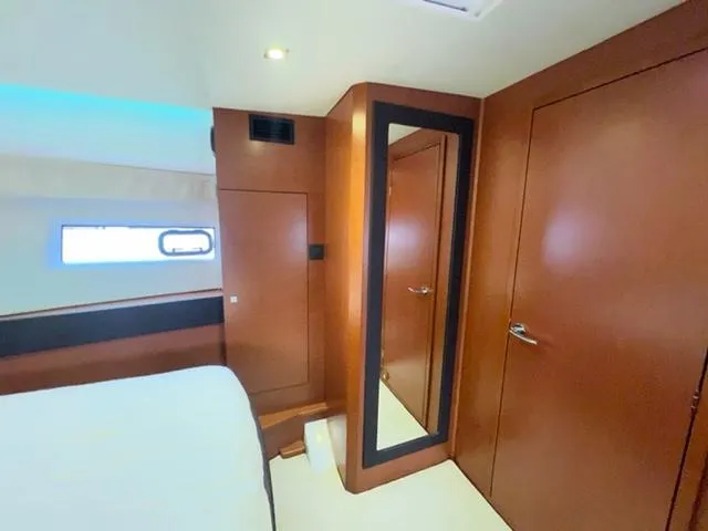 Slide: The Image of Interior cabin of 2014 Jeanneau NC14 yacht with wooden finishes and mirror. - 17