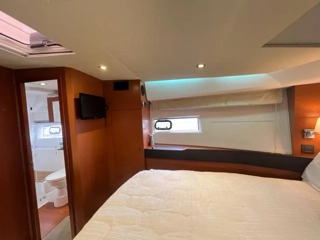 Slide: The Image of Luxurious cabin interior of 2014 Jeanneau NC14 yacht with cozy bed and ensuite bathroom. - 18