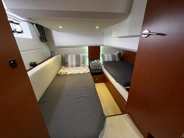 Slide: The Image of Cabin interior of 2014 Jeanneau NC14 with twin beds and modern decor. - 21