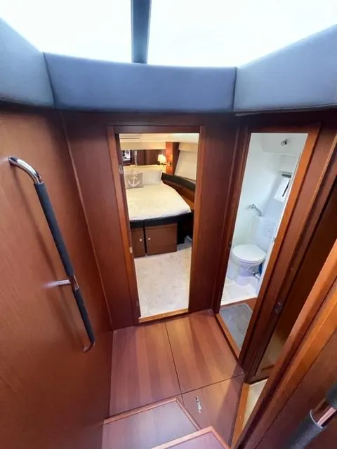 Slide: The Image of Interior view of 2014 Jeanneau NC14 yacht, featuring a cozy cabin and bathroom. - 22