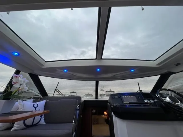 Slide: The Image of Interior of 2014 Jeanneau NC14 yacht with panoramic windows and modern helm. - 24