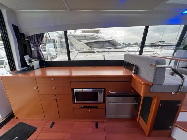 Slide: The Image of Interior of 2014 Jeanneau NC14 yacht with modern kitchen and large windows. - 28