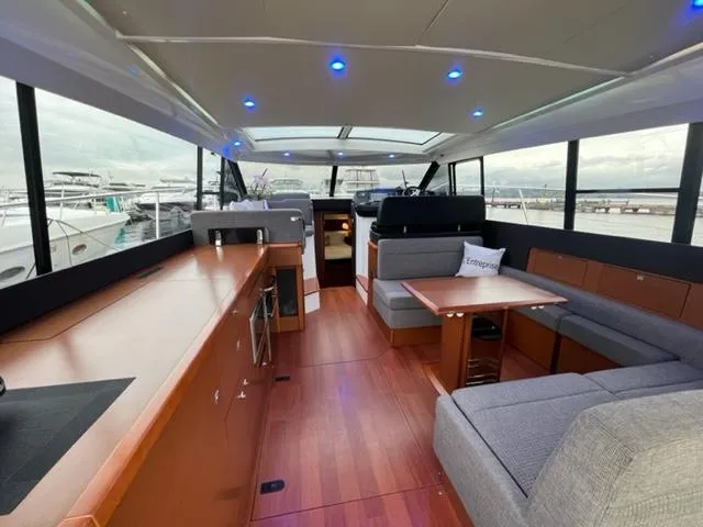 Slide: The Image of Interior of 2014 Jeanneau NC14 yacht with modern seating and wooden flooring. - 31