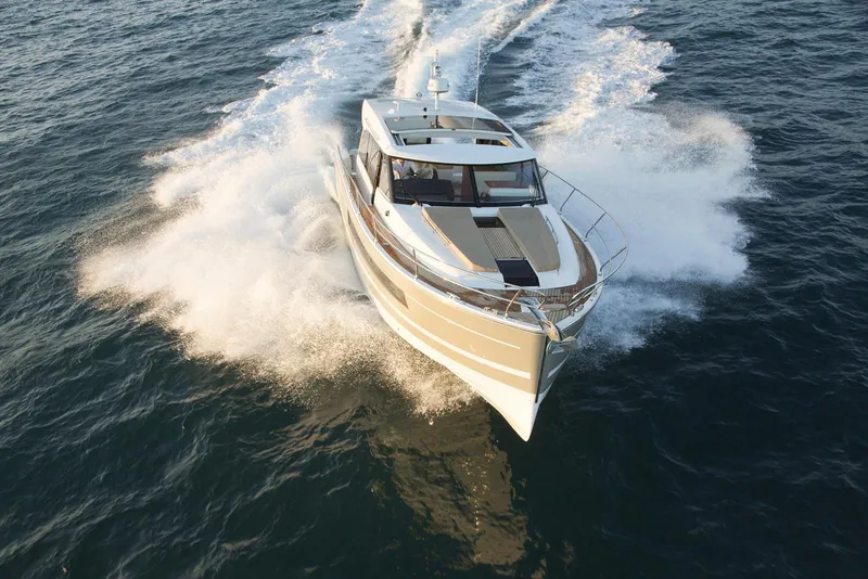 Slide: The Image of Jeanneau NC14 2014 motor yacht cruising swiftly on open water. - 5