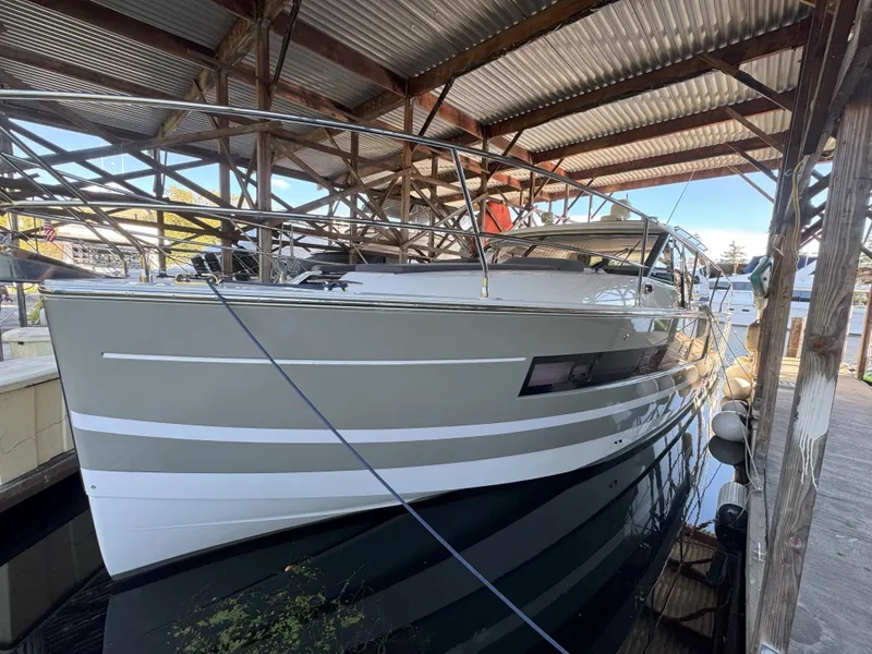 Slide: The Image of 2014 Jeanneau NC14 yacht docked under a metal roof. - 6