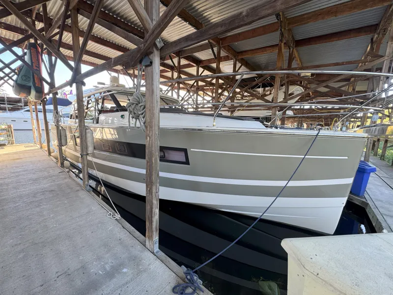 Slide: The Image of 2014 Jeanneau NC14 yacht docked in a covered marina. - 7