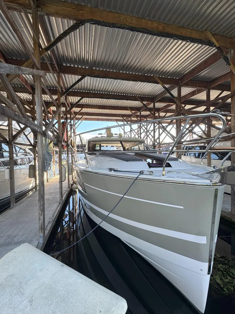 Slide: The Image of 2014 Jeanneau NC14 yacht docked in a covered marina. - 8