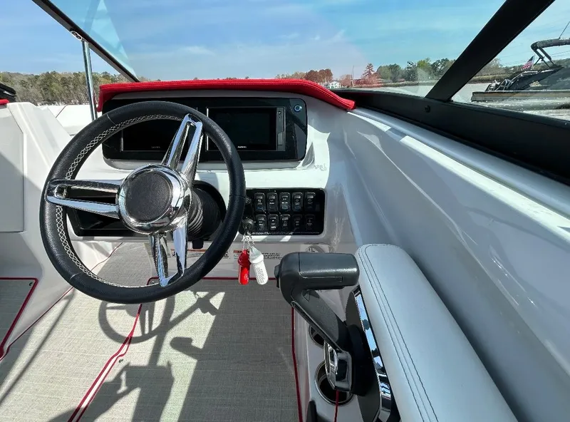 Slide: The Image of 2022 Regal LS2 boat cockpit with steering wheel and control panel. - 5
