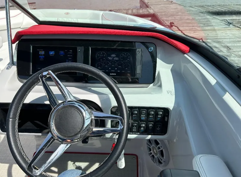 Slide: The Image of 2022 Regal LS2 boat dashboard with steering wheel and control panel. - 6