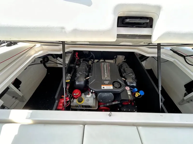 Slide: The Image of 2022 Regal LS2 boat engine compartment with open hatch, showcasing the engine and components. - 9
