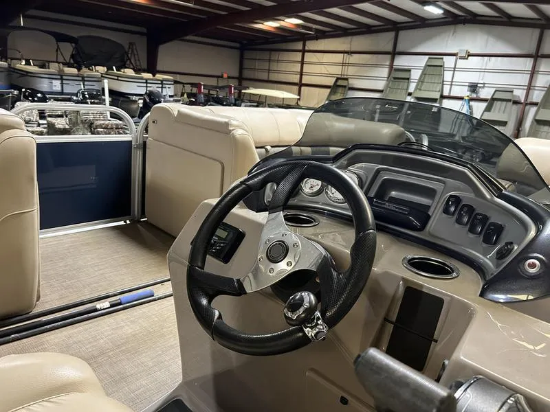 Slide: The Image of Interior of 2022 Sun Tracker PARTY BARGE® 20 DLX pontoon boat, featuring steering wheel and seating. - 15