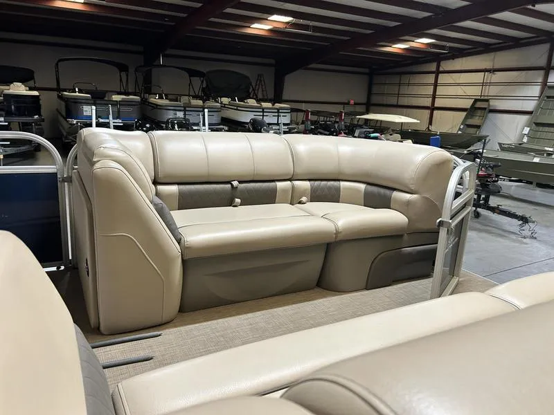 Slide: The Image of 2022 Sun Tracker PARTY BARGE® 20 DLX pontoon boat with beige seating in a showroom. - 17