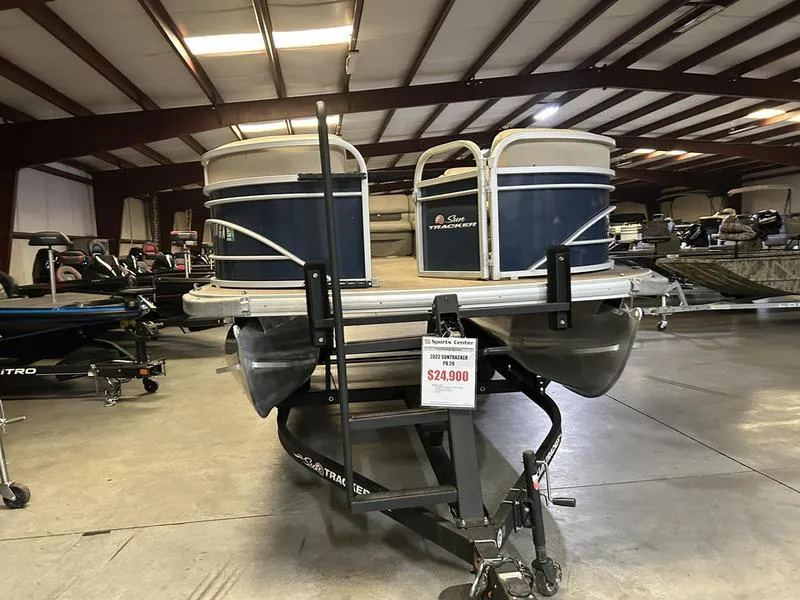 Slide: The Image of 2022 Sun Tracker PARTY BARGE® 20 DLX pontoon boat displayed in showroom, priced at $24,900. - 18
