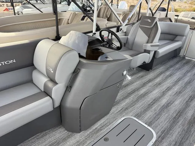 Slide: The Image of 2025 Bennington 21 S STERN RADIUS pontoon boat interior with gray seating and steering console. - 7