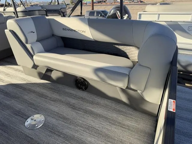 Slide: The Image of 2025 Bennington 22 S Cruise Jump boat interior with gray seating and carpeted flooring. - 4