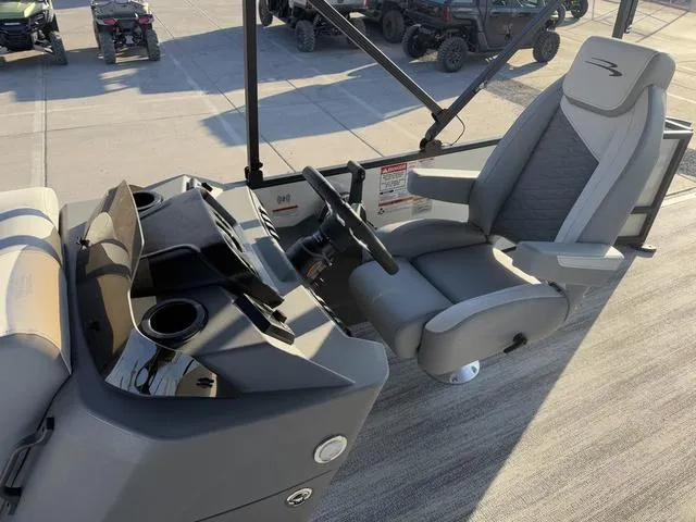 Slide: The Image of 2025 Bennington 22 S Cruise Jump boat interior with steering console and captain's chair. - 6