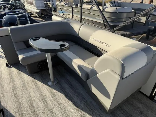 Slide: The Image of 2025 Bennington 22 S Cruise Jump pontoon boat interior with seating and table. - 8
