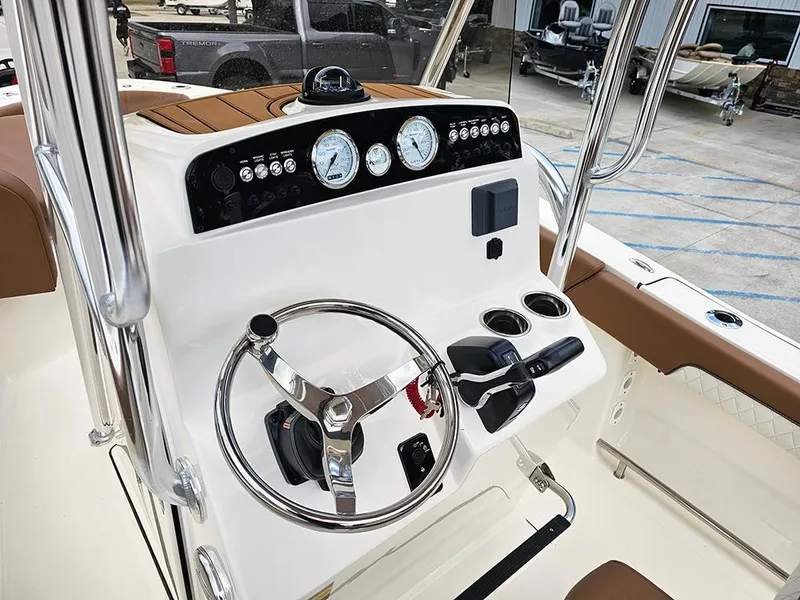 Slide: The Image of 2025 Pioneer 202 Islander boat dashboard with steering wheel and controls. - 12