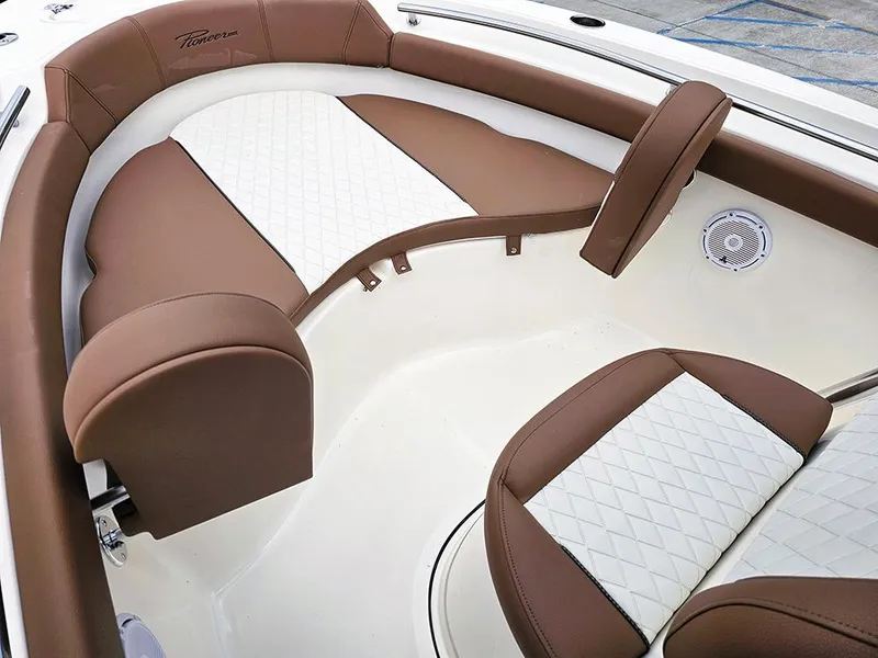 Slide: The Image of 2025 Pioneer 202 Islander boat interior with brown and white cushioned seating. - 16
