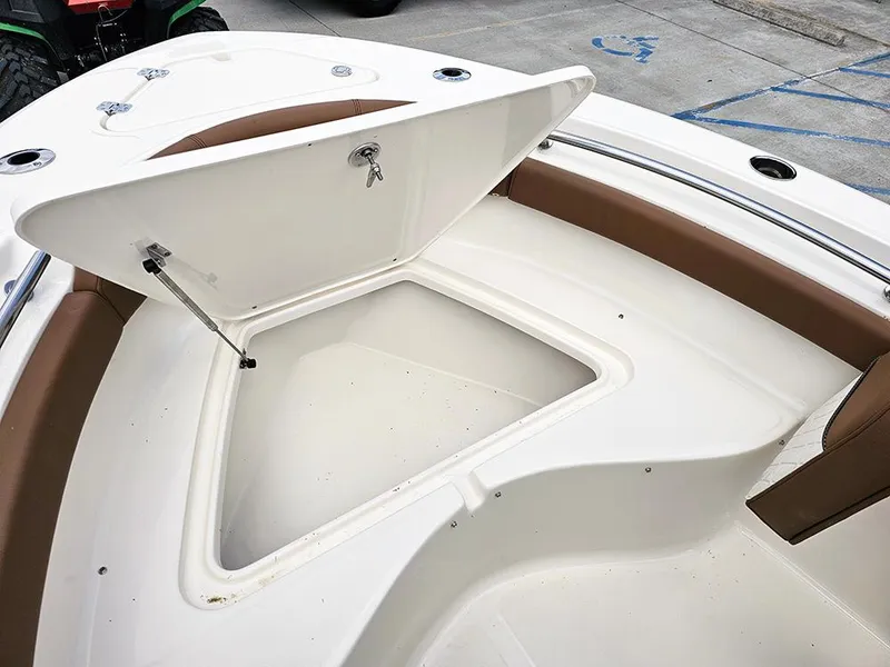 Slide: The Image of 2025 Pioneer 202 Islander boat with open storage compartment and brown seating. - 18