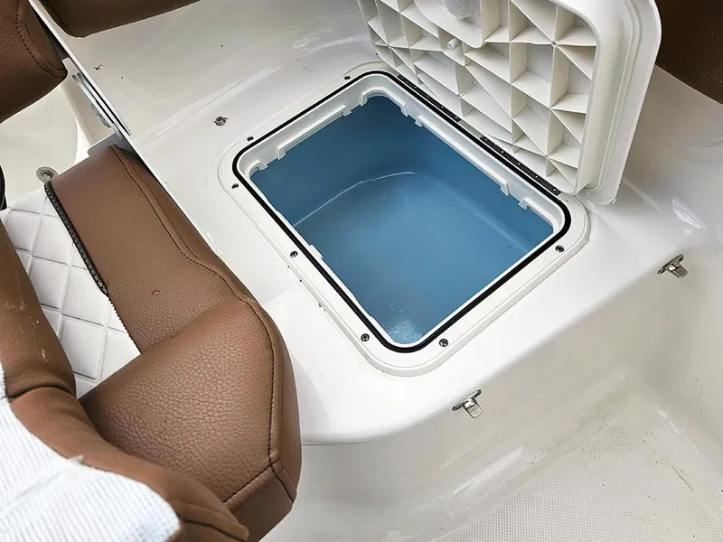 Slide: The Image of Open storage compartment in 2025 Pioneer 202 Islander boat with brown seating. - 8