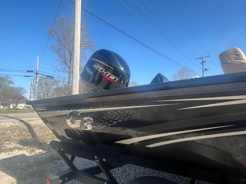 Slide: The Image of 2025 G3 Sportsman 1810 PFX boat with Yamaha engine, parked outdoors. - 2