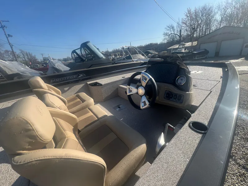Slide: The Image of 2025 G3 Sportsman 1810 PFX boat interior with steering wheel and beige seats. - 4