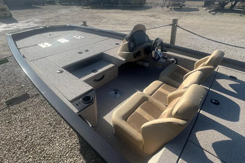 Slide: The Image of 2025 G3 Sportsman 1810 PFX boat interior with beige seats and steering console. - 5
