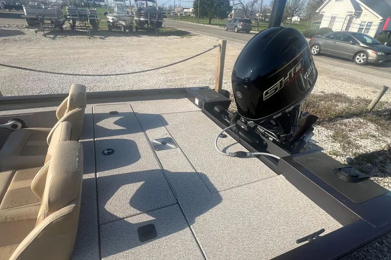 Slide: The Image of 2025 G3 Sportsman 1810 PFX boat with motor, beige seating, and spacious deck. - 7