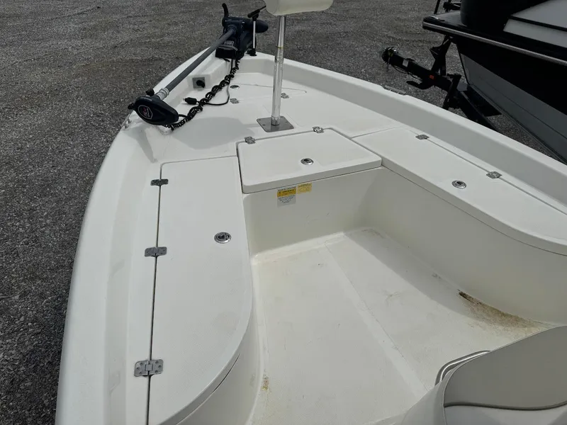 Slide: The Image of 2015 NauticStar 2110 Sport boat deck with seating and storage compartments. - 2