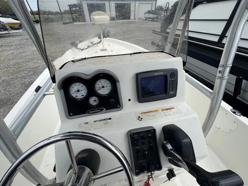 Slide: The Image of 2015 NauticStar 2110 Sport boat dashboard with steering wheel and navigation instruments. - 6