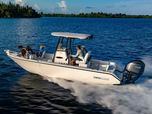 Slide: The Image of 2024 Pathfinder 2400 TRS boat cruising on a serene lake with passengers enjoying the ride. - 1