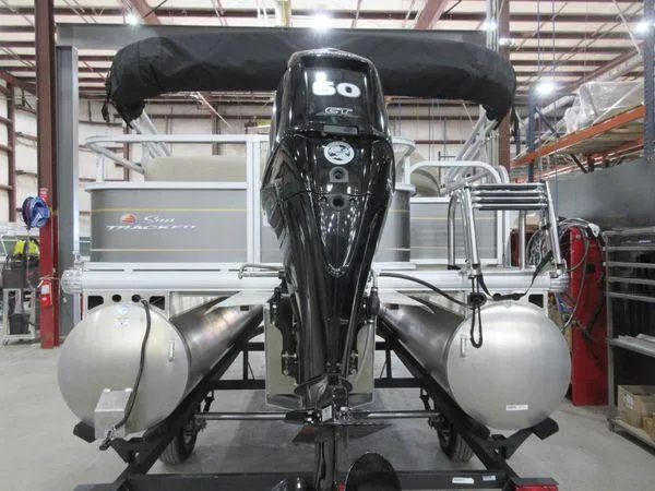 Slide: The Image of 2023 Sun Tracker Party Barge 18 DLX pontoon boat in a warehouse setting. - 2