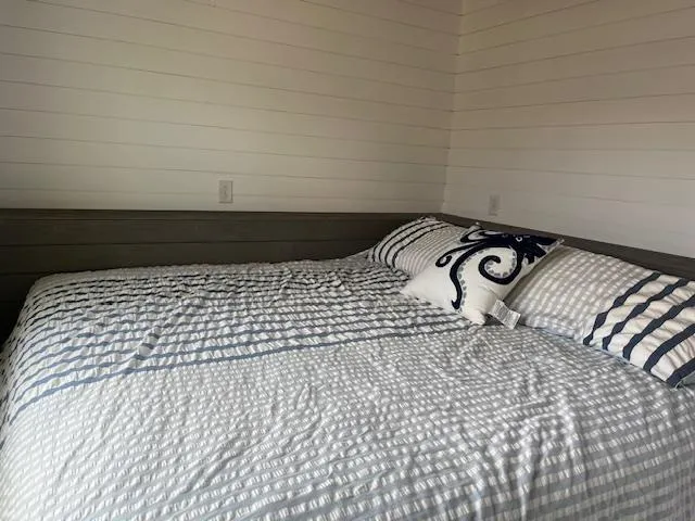 Slide: The Image of Cozy bedroom in 2020 Harbor Cottage 16 x 84 model with striped bedding. - 19