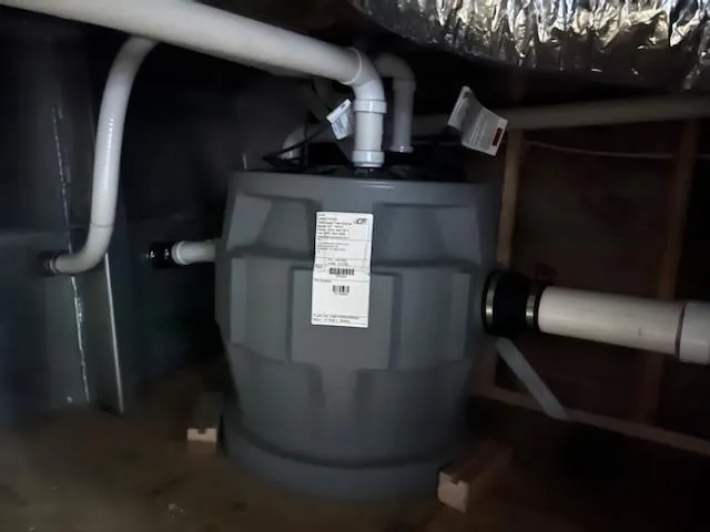 Slide: The Image of Basement plumbing system with pipes and a large gray tank, Harbor Cottage 16 x 84, 2020 model. - 25