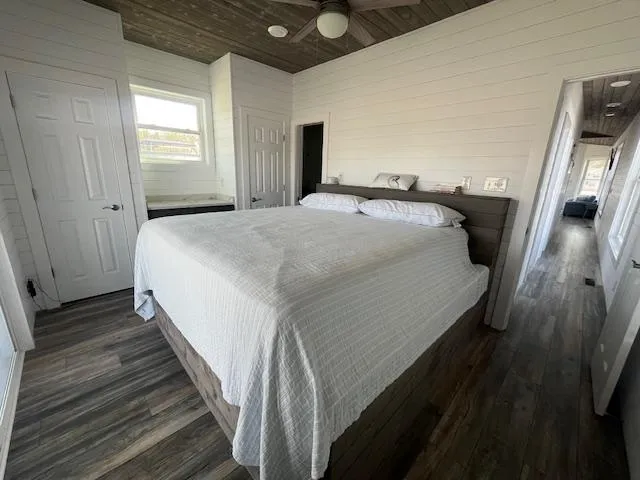 Slide: The Image of Modern bedroom in 2020 Harbor Cottage 16 x 84, featuring wood floors and white bedding. - 27