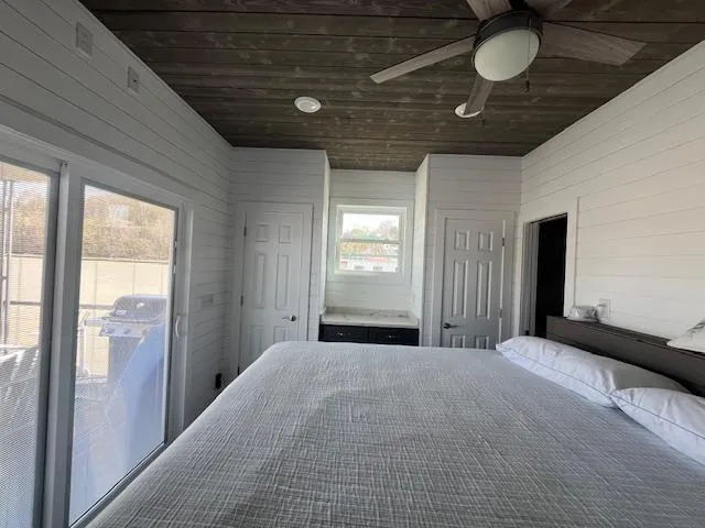 Slide: The Image of Modern bedroom in 2020 Harbor Cottage model, featuring wood ceiling, ceiling fan, and large bed. - 28