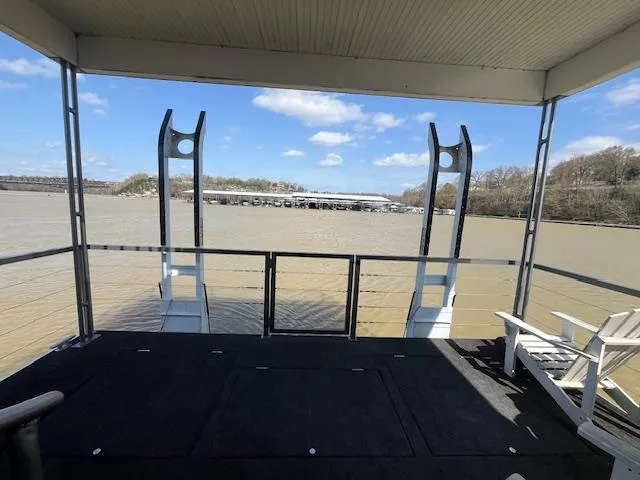 Slide: The Image of Houseboat deck view over river, featuring chairs and clear skies. - 33