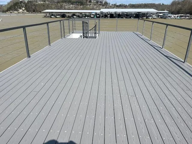 Slide: The Image of Rooftop deck of 2020 Harbor Cottage 16 x 84 houseboat with railing, overlooking marina. - 39