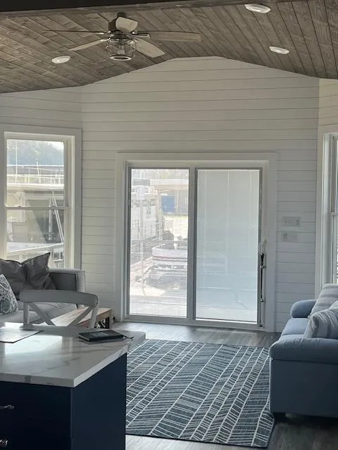 Slide: The Image of Modern Harbor Cottage interior with large windows, sliding door, and cozy seating area. - 41