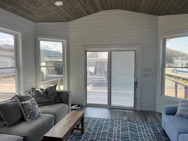 Slide: The Image of Modern living room in 2020 Harbor Cottage model, featuring large windows and cozy seating. - 8